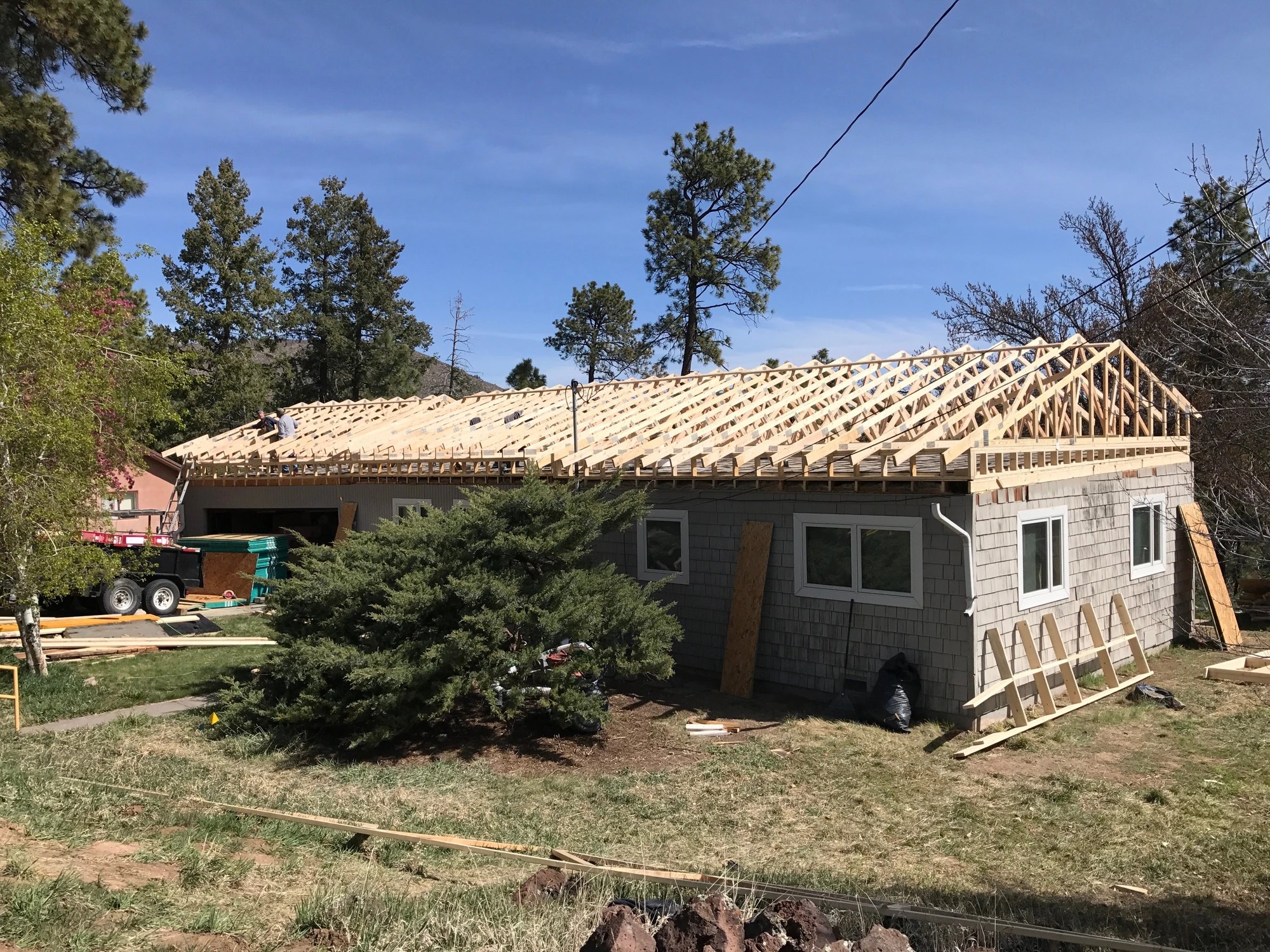 A flat-roofed home reframed with new pitched roof trusses