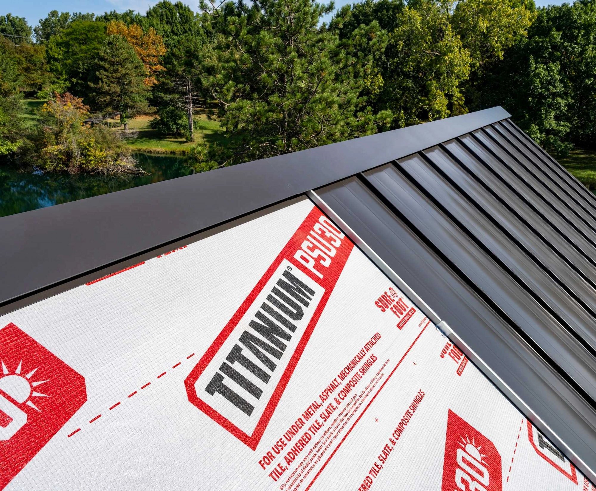 Standing-seam metal roof on a timber home — detail 2