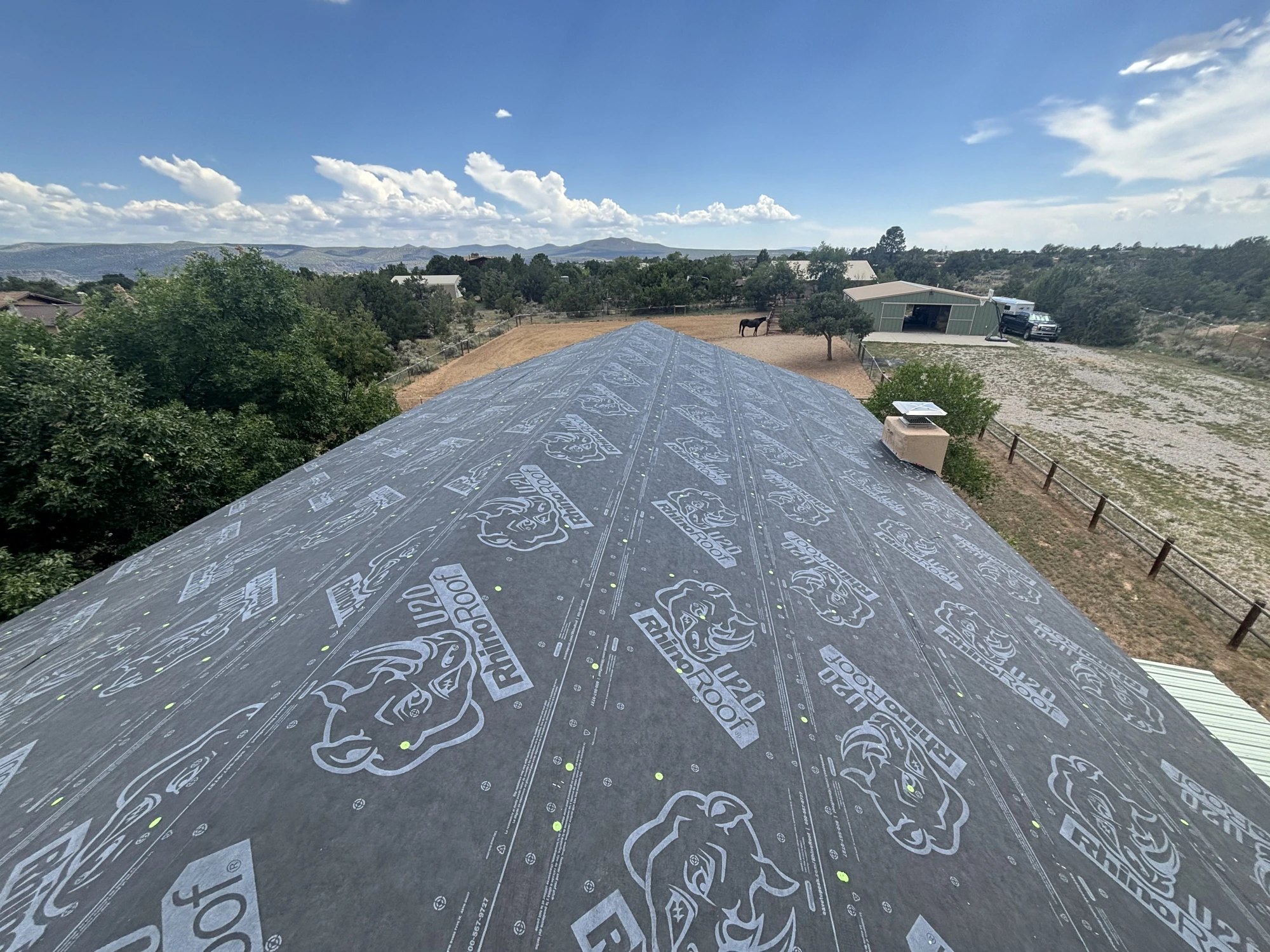 Standing-seam metal roof on a timber home — detail 3