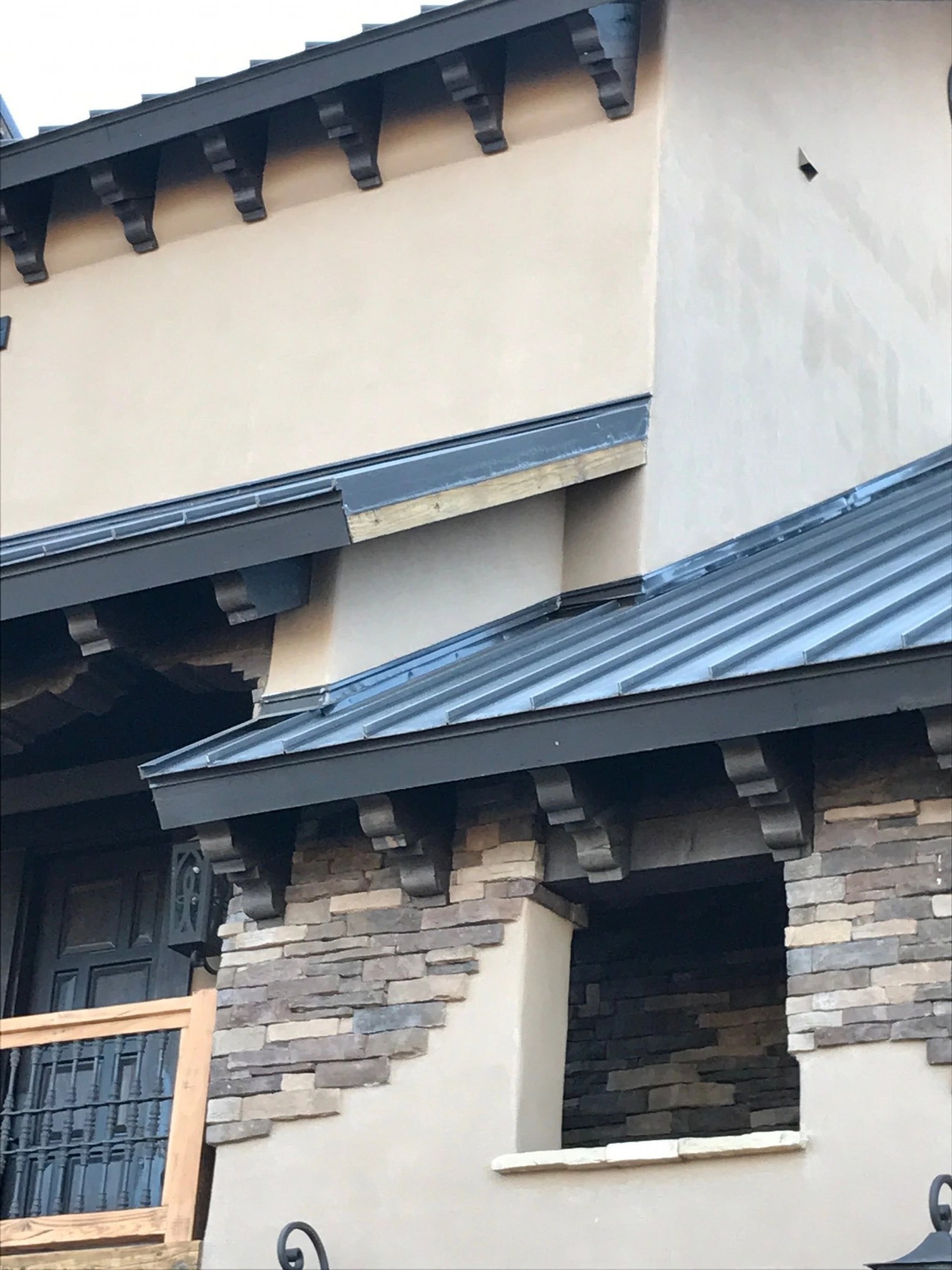 Perforated metal soffit and metal fascia along a metal roof edge — detail 2