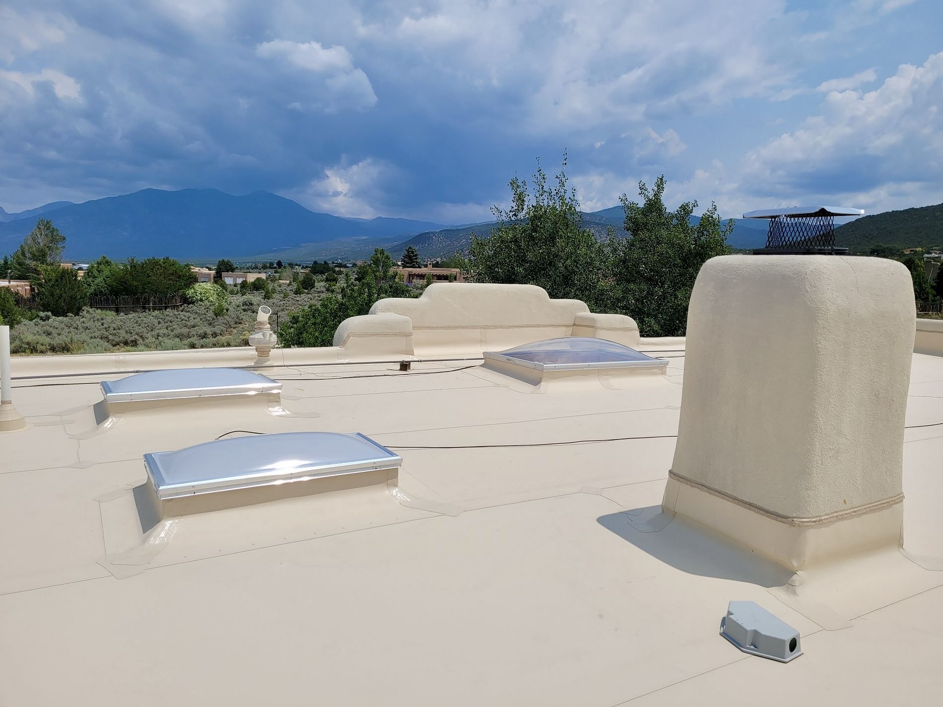 White fire-rated TPO roof with skylights on a New Mexico home